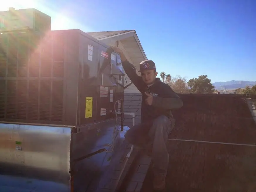 HVAC technician performing HVAC Inspection on a rooftop unit in Tega Cay
